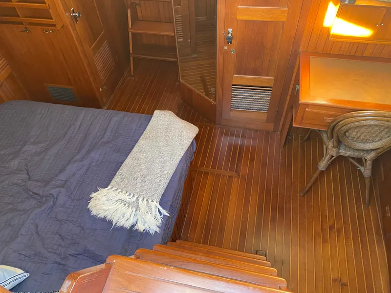 Slide: The Image of Cozy cabin interior of 1983 DeFever 41 yacht with wooden furnishings and bed. - 22