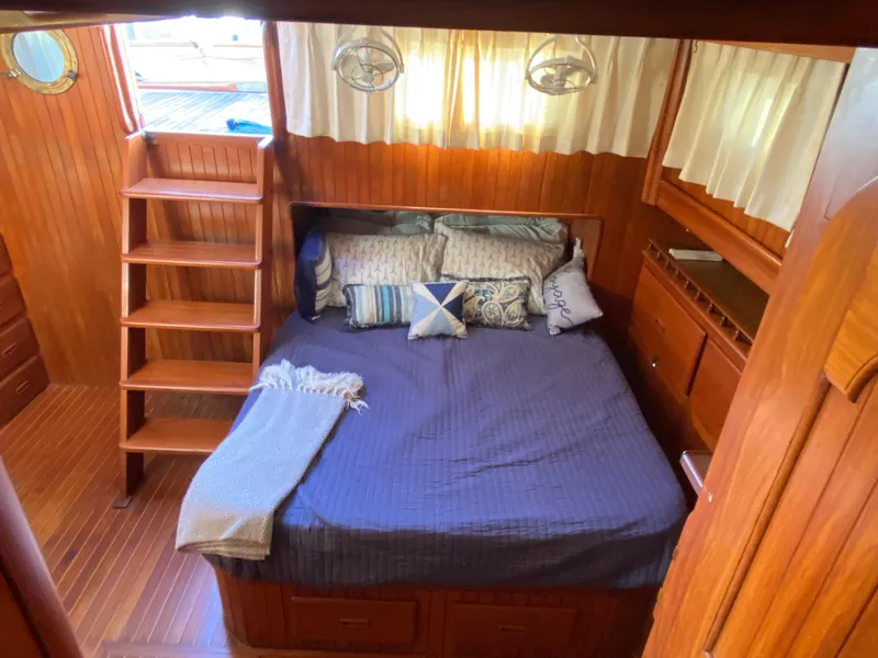 Slide: The Image of Cozy cabin interior of 1983 DeFever 41 yacht with wooden decor and comfortable bedding. - 27
