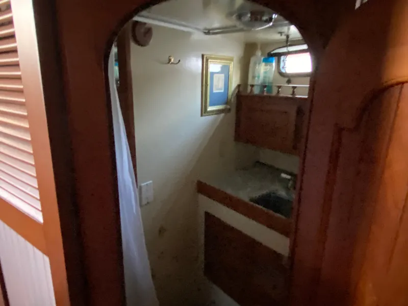 Slide: The Image of 1983 DeFever 41 yacht bathroom with wooden cabinetry and framed artwork. - 34