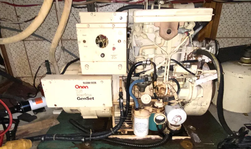 Slide: The Image of 1983 DeFever 41 Onan Marine GenSet engine in a boat's engine room. - 35