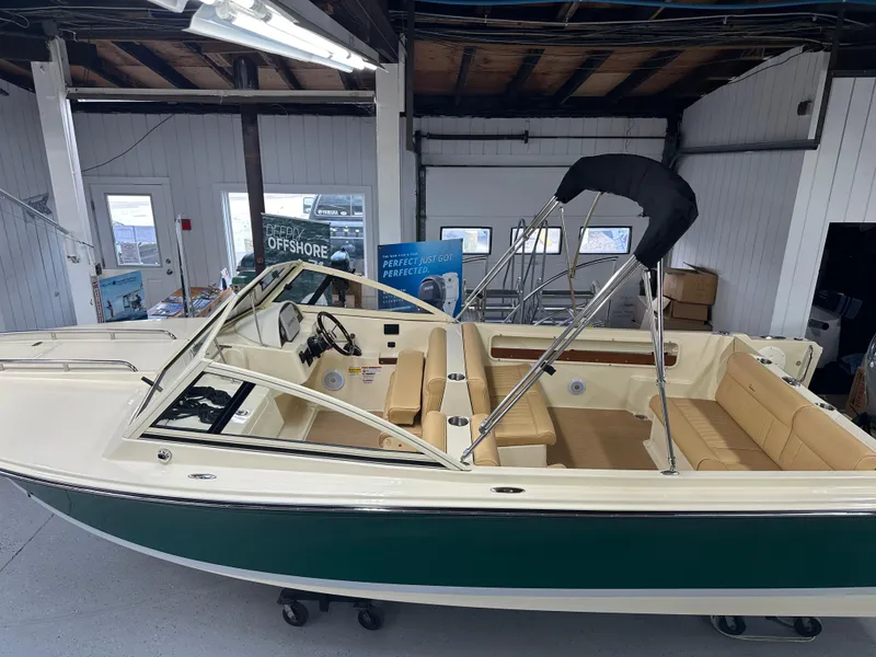 Slide: The Image of 2025 Rossiter 20 Day Boat in showroom, featuring sleek design and comfortable seating. - 3