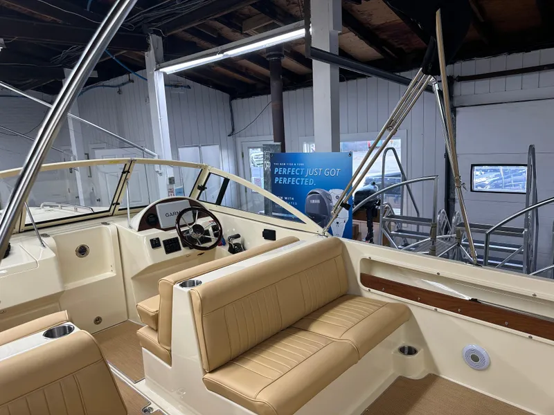 Slide: The Image of 2025 Rossiter 20 Day Boat interior with tan seating and modern dashboard. - 5