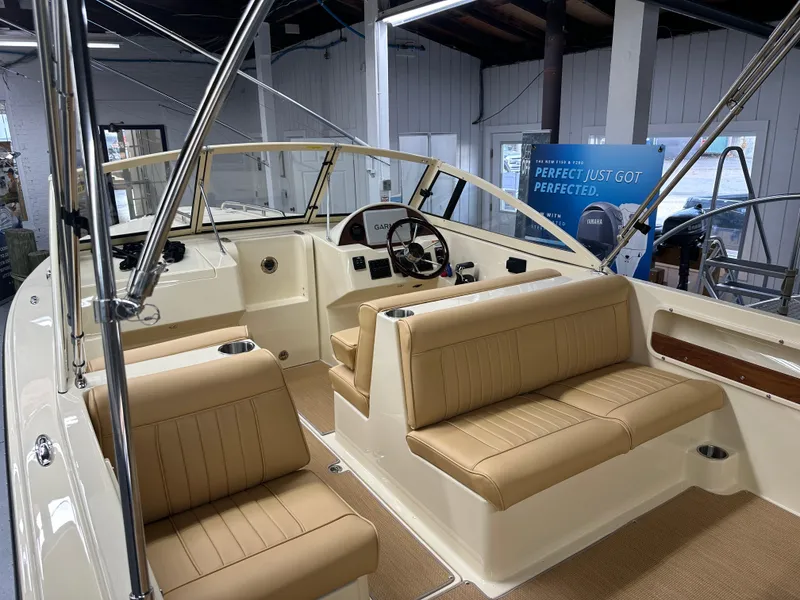 Slide: The Image of 2025 Rossiter 20 Day Boat interior with tan seating and modern dashboard. - 6
