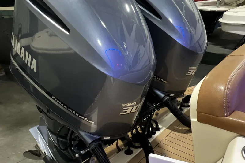 Slide: The Image of 2021 Scout 305 LXF with twin Yamaha outboard engines, docked on a wooden platform. - 11