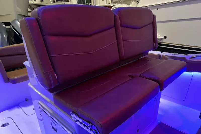 Slide: The Image of Luxurious seating on 2021 Scout 305 LXF boat with ambient blue lighting. - 22
