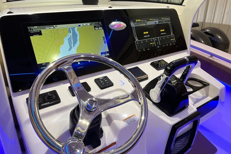 Slide: The Image of 2021 Scout 305 LXF boat dashboard with navigation screens and controls. - 30