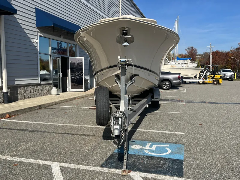Slide: The Image of 2021 Scout 305 LXF boat on trailer in parking lot. - 4