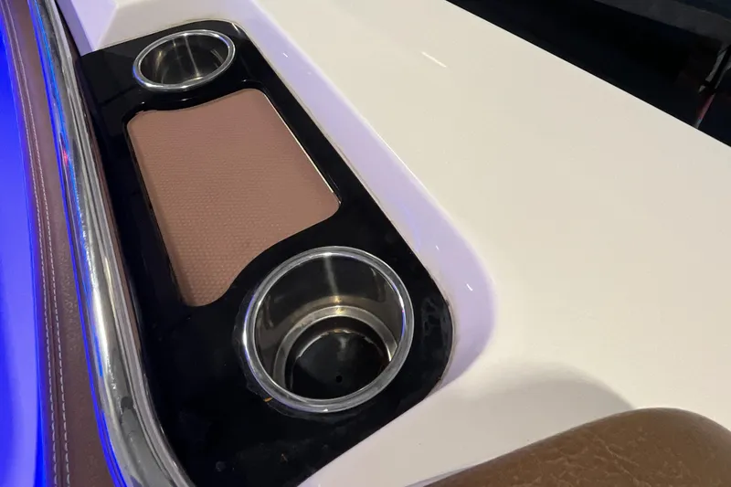 Slide: The Image of 2021 Scout 305 LXF boat cup holders and storage compartment detail. - 42