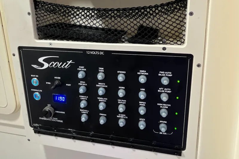 Slide: The Image of Control panel of a 2021 Scout 305 LXF boat with various switches and indicators. - 45
