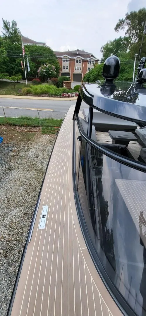 Slide: The Image of Control panel of 2023 VanDutch 56 yacht with dual Garmin displays and navigation controls. - 13