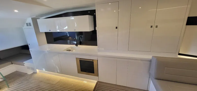 Slide: The Image of Luxurious interior of 2023 VanDutch 56 yacht with modern seating and ambient lighting. - 21