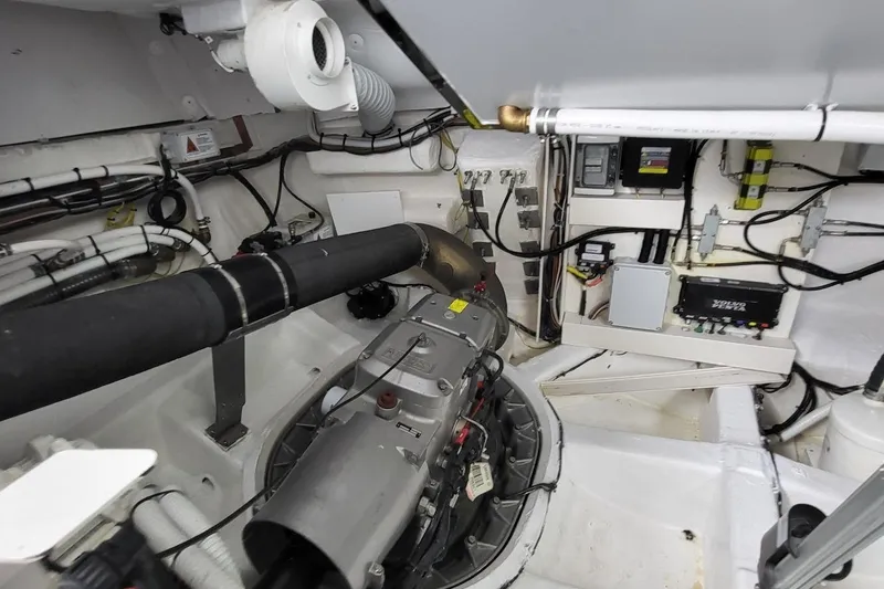 Slide: The Image of Engine room of 2023 VanDutch 56 yacht, showcasing mechanical components and wiring. - 37