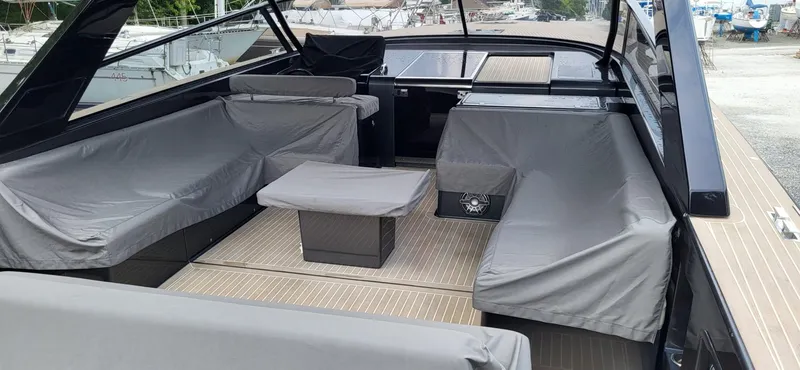 Slide: The Image of 2023 VanDutch 56 yacht in a boatyard, showcasing sleek deck design. - 7