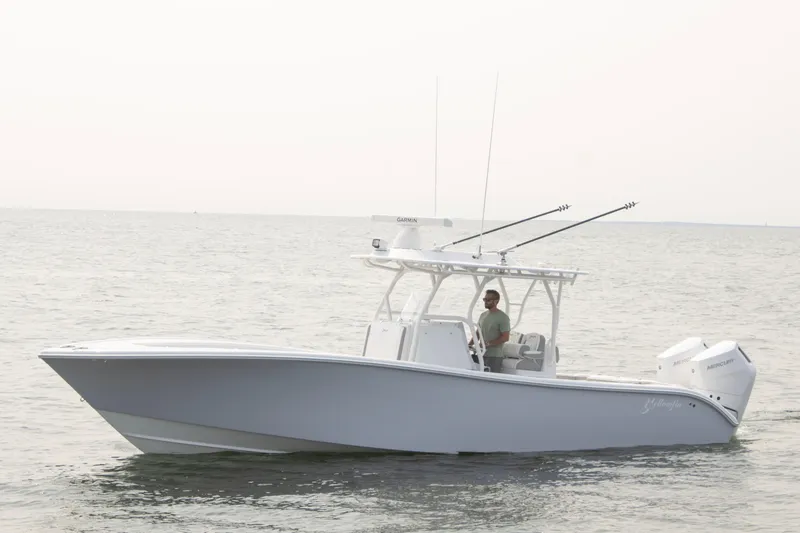 Slide: The Image of 2025 Yellowfin 32 Offshore boat cruising on calm waters. - 1