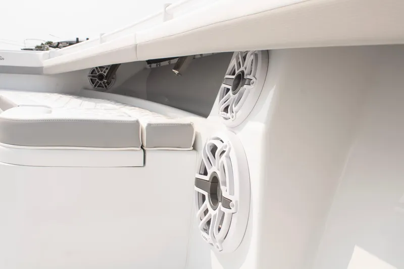 Slide: The Image of 2025 Yellowfin 32 Offshore boat interior with speakers and cushioned seating. - 10