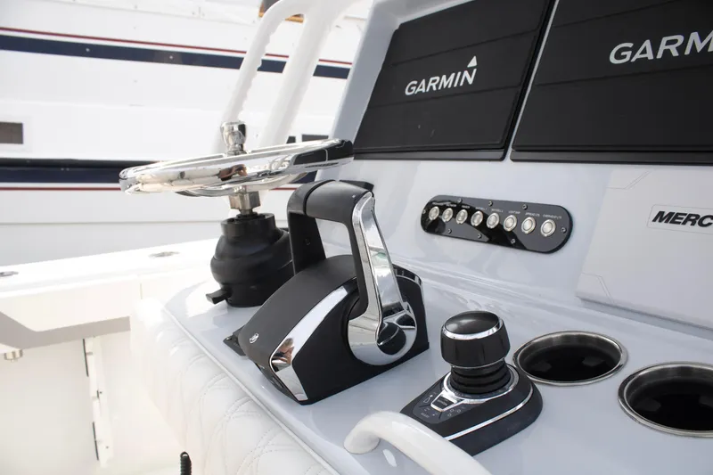 Slide: The Image of 2025 Yellowfin 32 Offshore boat dashboard with Garmin navigation and Mercury controls. - 14