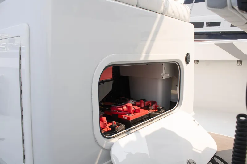 Slide: The Image of 2025 Yellowfin 32 Offshore boat battery compartment with red batteries visible. - 18