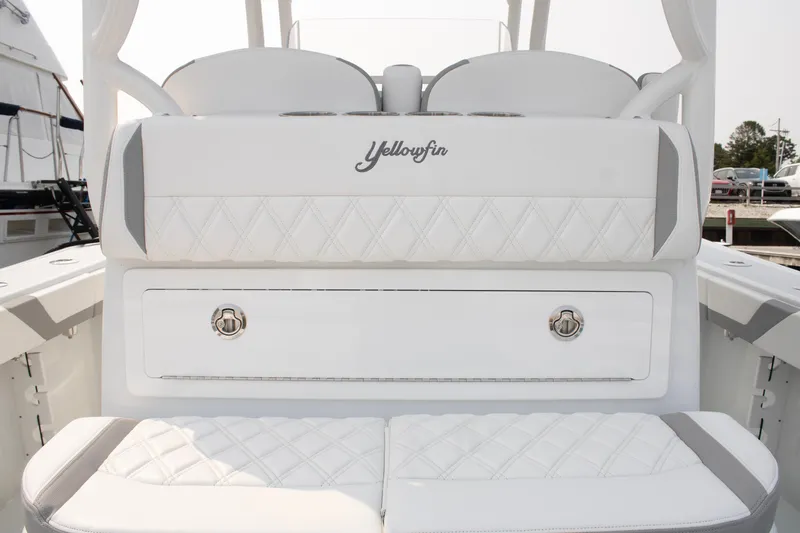 Slide: The Image of 2025 Yellowfin 32 Offshore boat interior with white cushioned seating. - 19
