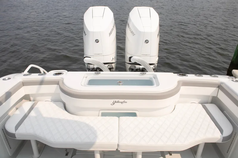 Slide: The Image of 2025 Yellowfin 32 Offshore boat with twin Mercury engines on calm water. - 22