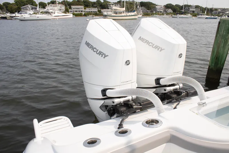 Slide: The Image of 2025 Yellowfin 32 Offshore with twin Mercury outboard engines docked by the water. - 24