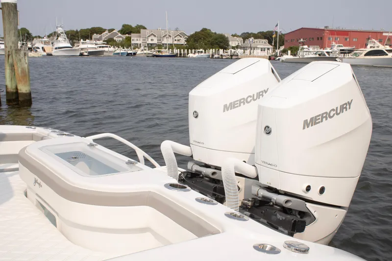 Slide: The Image of 2025 Yellowfin 32 Offshore boat with dual Mercury outboard engines docked at marina. - 25