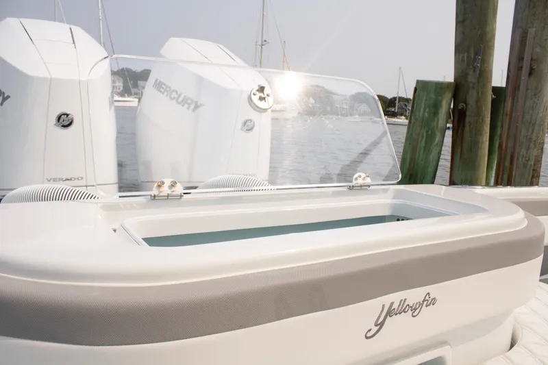 Slide: The Image of 2025 Yellowfin 32 Offshore boat with Mercury engines, docked by wooden posts. - 26