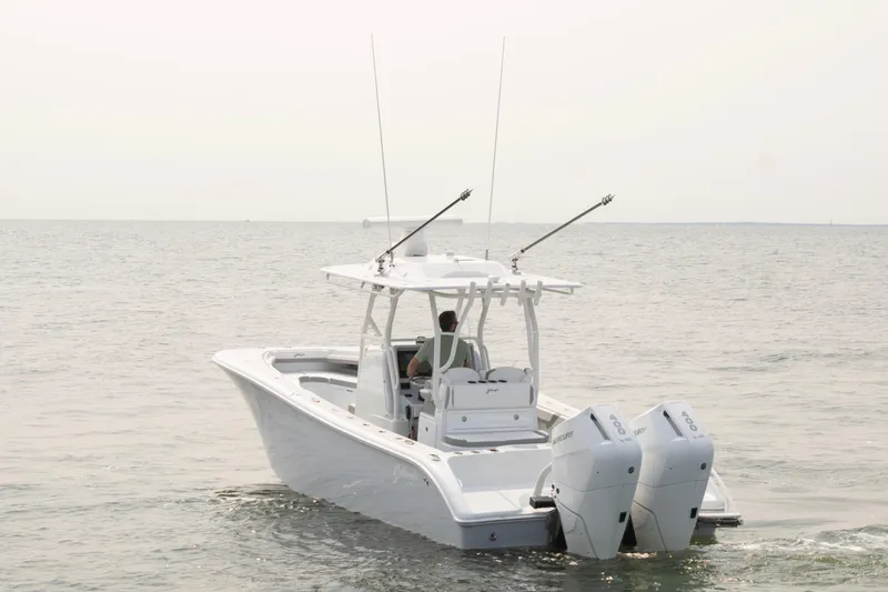 Slide: The Image of 2025 Yellowfin 32 Offshore boat on calm sea with dual outboard engines. - 6