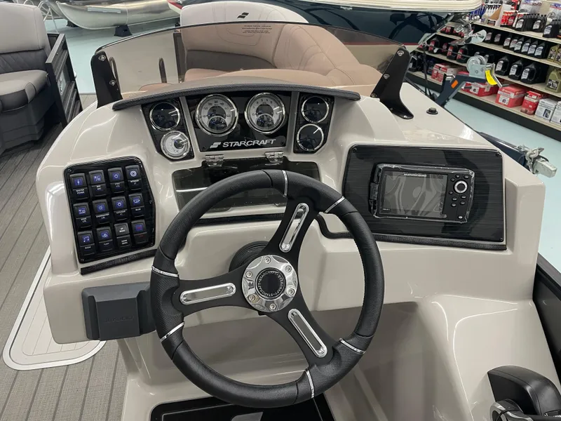 Slide: The Image of 2024 Starcraft SLS 5 boat dashboard with steering wheel and control panel. - 17