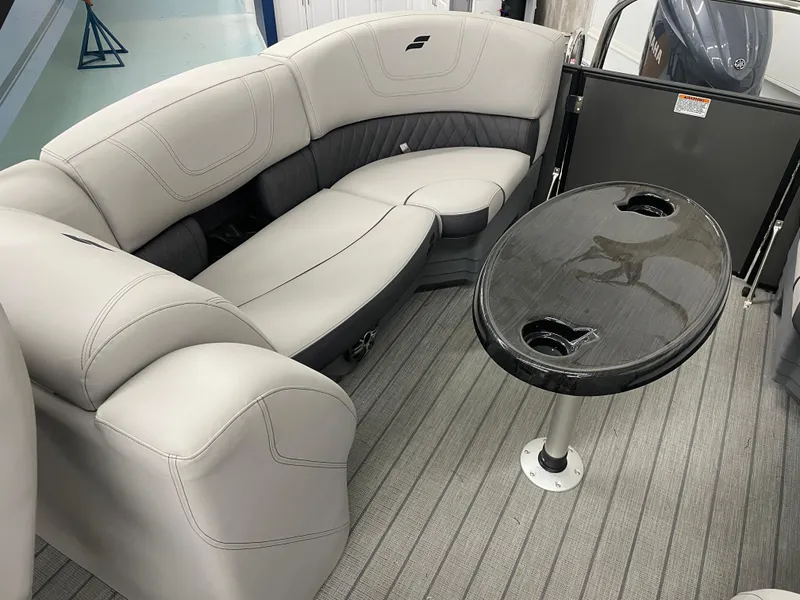 Slide: The Image of 2024 Starcraft SLS 5 boat interior with plush seating and sleek table design. - 18