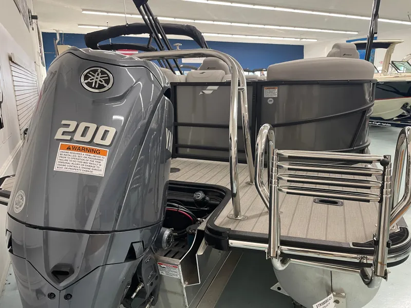 Slide: The Image of 2024 Starcraft SLS 5 boat with Yamaha 200 engine, rear view in showroom. - 2