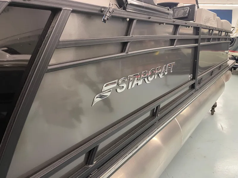 Slide: The Image of 2024 Starcraft SLS 5 pontoon boat, sleek design, side view. - 4