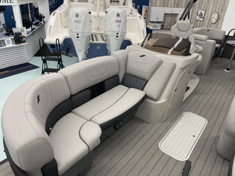 Slide: The Image of 2024 Starcraft SLS 5 boat interior with plush seating and dual outboard motors. - 8