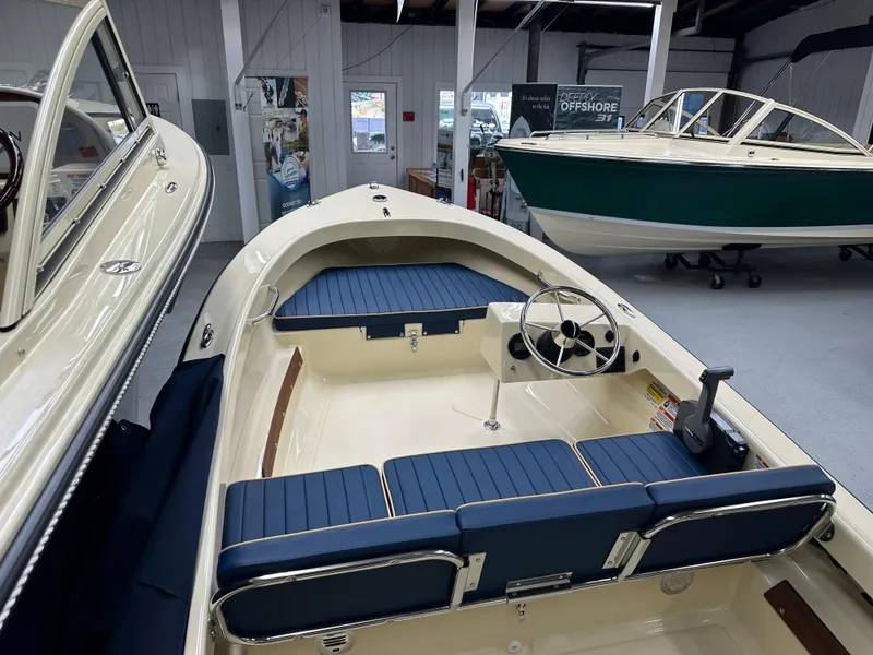 Slide: The Image of 2025 Rossiter 14 boat interior with blue seating in showroom. - 10