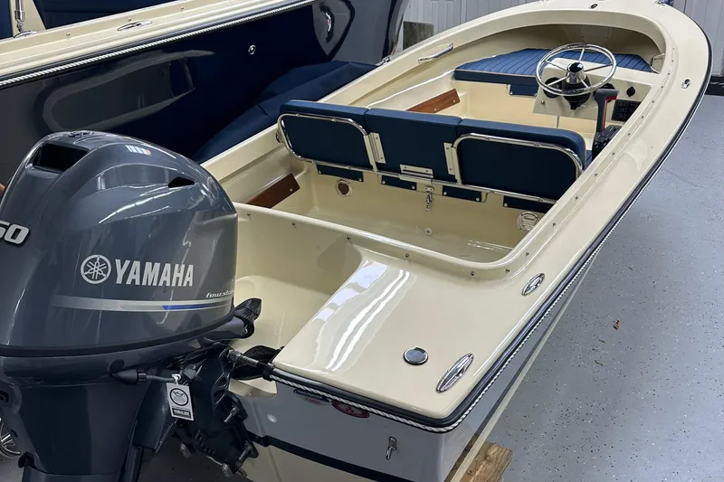 Slide: The Image of 2025 Rossiter 14 boat with Yamaha outboard motor in showroom. - 12