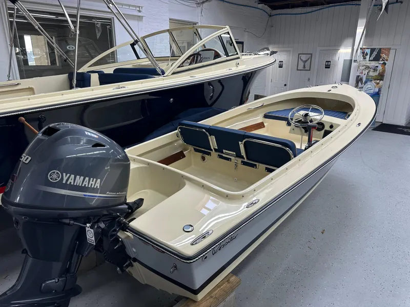 Slide: The Image of 2025 Rossiter 14 boat with Yamaha outboard motor in showroom. - 2