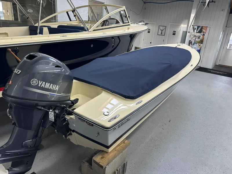 Slide: The Image of 2025 Rossiter 14 boat with Yamaha outboard motor, covered and displayed indoors. - 4