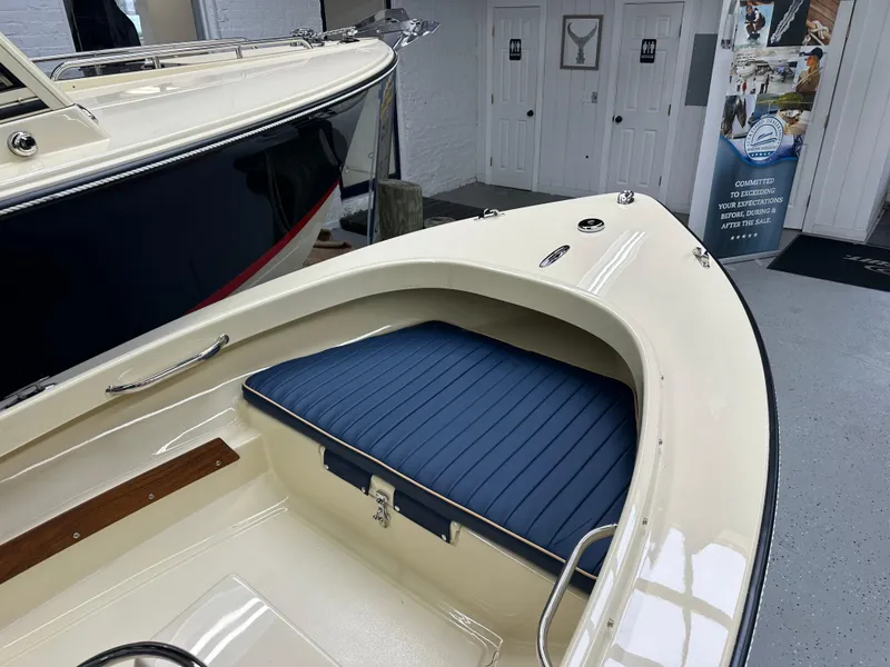 Slide: The Image of 2025 Rossiter 14 boat with blue seating in showroom. - 6