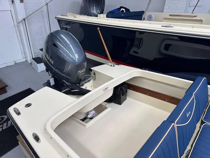 Slide: The Image of 2025 Rossiter 14 boat with Yamaha 50 outboard motor in showroom. - 8