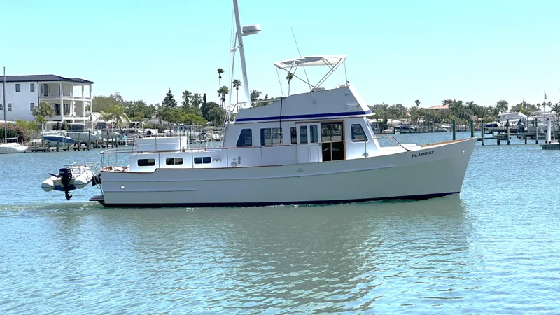 Slide: The Image of 1972 Bristol 42 Offshore Trawler cruising in a sunny marina. - 1