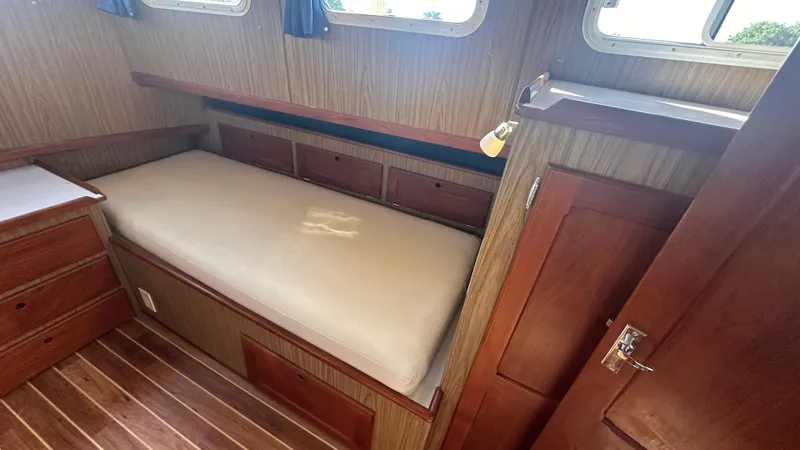 Slide: The Image of 1972 Bristol 42 Offshore Trawler cabin with wooden interior and single bed. - 14
