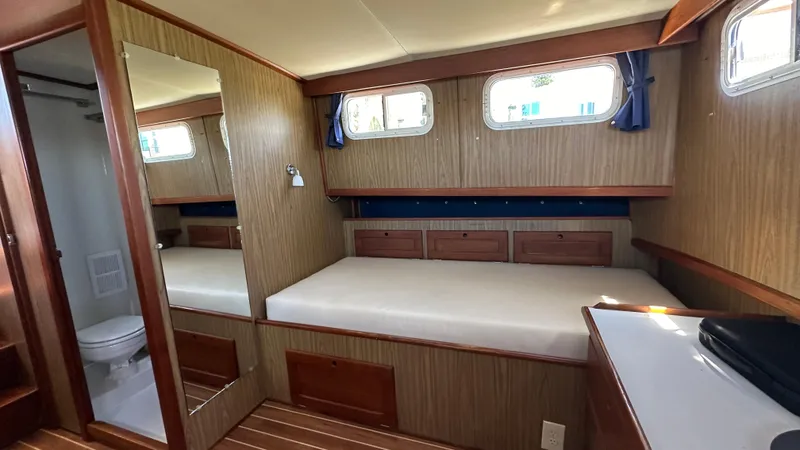Slide: The Image of Interior of 1972 Bristol 42 Offshore Trawler with bed, wood paneling, and windows. - 16