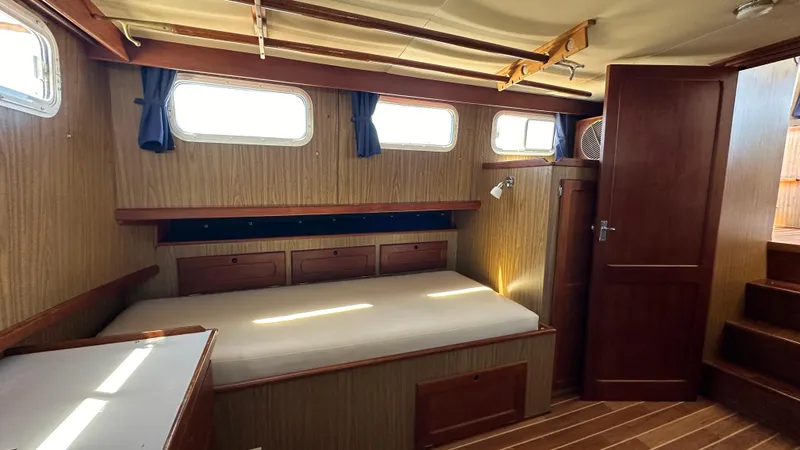Slide: The Image of Interior of 1972 Bristol 42 Offshore Trawler with wooden paneling and cozy bed. - 17
