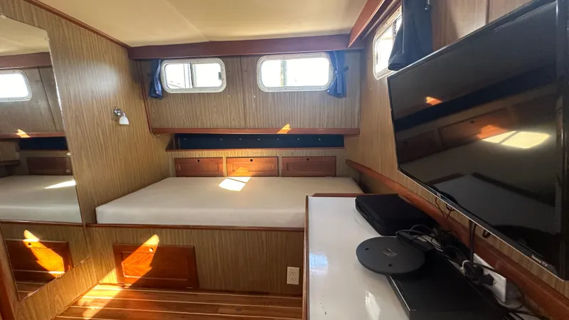 Slide: The Image of Interior of 1972 Bristol 42 Offshore Trawler with bed, TV, and wood paneling. - 18