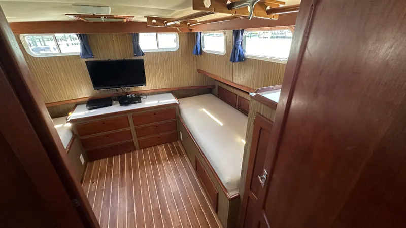 Slide: The Image of Interior of 1972 Bristol 42 Offshore Trawler with wood paneling, twin beds, and a TV. - 20