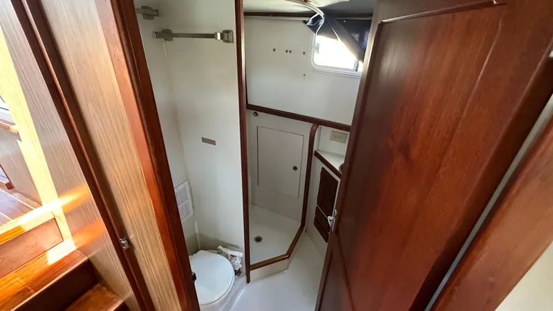 Slide: The Image of 1972 Bristol 42 Offshore Trawler bathroom with wooden cabinetry and compact design. - 21