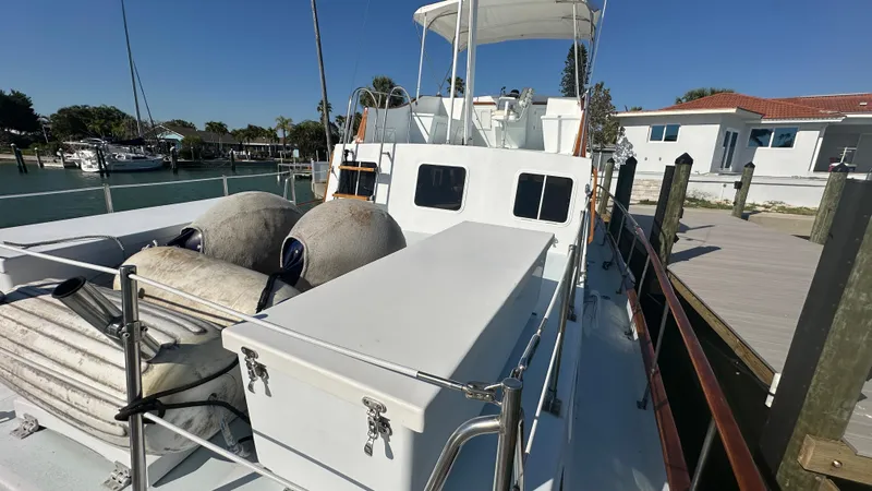 Slide: The Image of 1972 Bristol 42 Offshore Trawler docked, featuring deck storage and nautical equipment. - 31