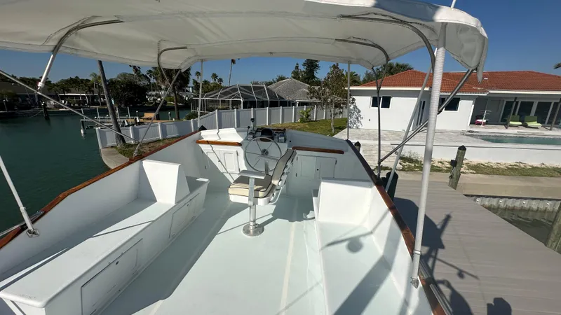 Slide: The Image of 1972 Bristol 42 Offshore Trawler, spacious deck, docked by waterfront home. - 34