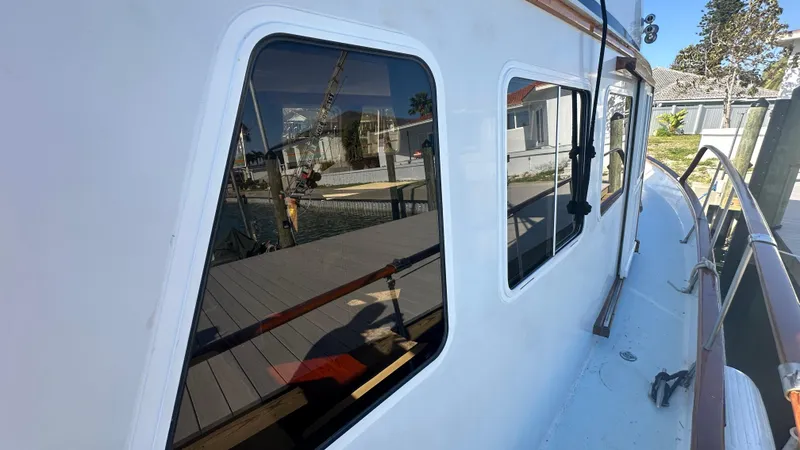 Slide: The Image of 1972 Bristol 42 Offshore Trawler, docked with reflective windows and wooden railings. - 37
