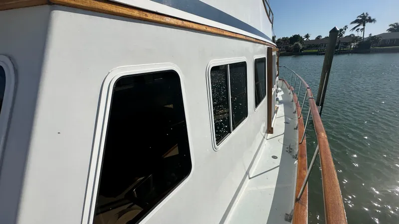 Slide: The Image of 1972 Bristol 42 Offshore Trawler, side view, docked on calm water. - 38