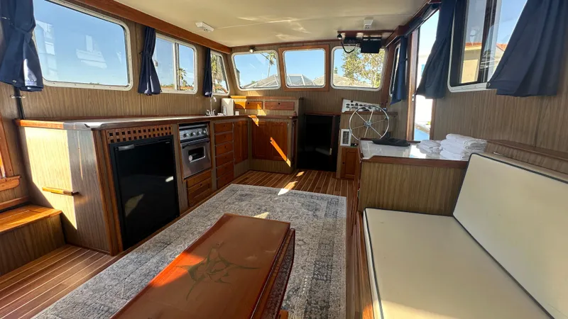 Slide: The Image of Interior of 1972 Bristol 42 Offshore Trawler with wood paneling and cozy seating area. - 5